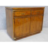 An American walnut brass bound serving cabinet with fold out top, on casters. H.84 W.102 D.49cm