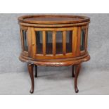 An Eastern carved teak vitrine cabinet with lift off oval tray. H.78 W.73 D.50cm