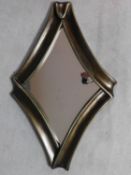 A contemporary bronzed frame diamond shaped Antigua wall mirror by Equipo Schuller. 65x102cm