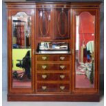 A late 19th century mahogany and inlaid compactum wardrobe fitted with central cupboard and