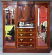 A late 19th century mahogany and inlaid compactum wardrobe fitted with central cupboard and