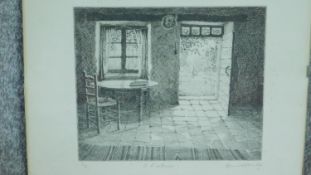 A glazed and signed etching by British artist Annie Williams, titled 'A L'Interieur'. Signed by