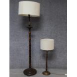 An oak turned standard lamp with circular base along with an oak turned table lamp with rope