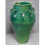 A large green drip glazed sharab wine vessel with multiple handles. H.70cm