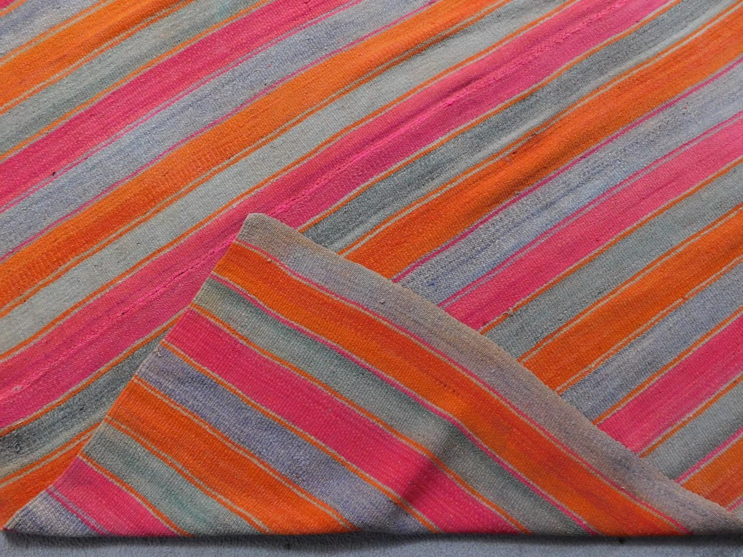 A contemporary linear rug with repeating orange and pink stripes on a grey field 180x200cm - Image 3 of 3