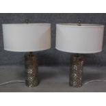 A pair of cylindrical textured metal table lamps with cross hatched design. H.60cm