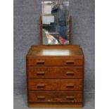 A vintage oak dressing chest of four drawers with swing mirror back, makers label to the back. H.141