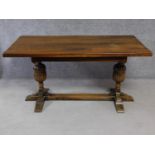 A Jacobean style oak refectory style dining table on carved stretchered baluster supports. H.77 W.