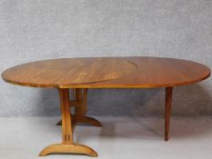 A vintage fruitwood vineyard folding table with a custom made leaf on stretchered supports. H.70 W.