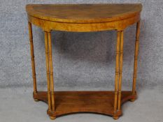 A Georgian style walnut and burr elm crossbanded demi lune console table, makers label to underside.