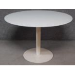 A circular glass topped table on metal pedestal base. H.73 W.110 D.110cm