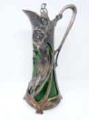 A WMF style Warszawa Art Nouveau Silver plate claret jug, with bottle green liner, berries and