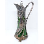 A WMF style Warszawa Art Nouveau Silver plate claret jug, with bottle green liner, berries and