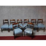 A set of eight mahogany dining chairs with bar backs, carved splats and stuffover seats on turned