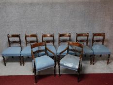 A set of eight mahogany dining chairs with bar backs, carved splats and stuffover seats on turned