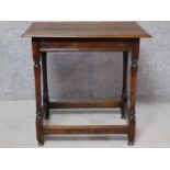 An antique country oak side table on turned stretchered supports. H.70 W.72 D.50cm