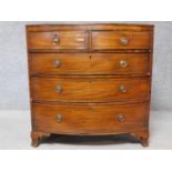 A Georgian mahogany and ebony strung bowfronted chest of two short over three long drawers on shaped