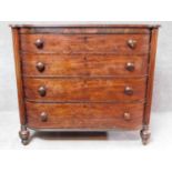 A late Georgian mahogany bowfronted chest of four long drawers flanked by reeded pilasters on turned