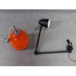 A vintage orange glass and chrome ceiling lamp along with a matte black metal screw on adjustable
