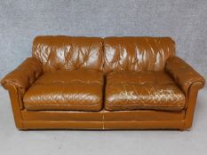 A vintage brown leather upholstered button backed two seater sofa. H.70 W.170 D.90cm