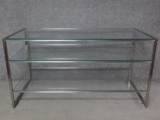 A vintage chrome framed three tier display counter with plate glass shelves. H.82 W.156 D.73cm