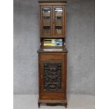 A late 19th century oak two section cabinet with well carved classical style panel door. H.211 W.