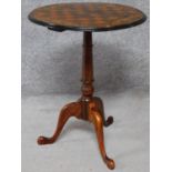 A Victorian mahogany, rosewood and satinwood inlaid chess top table on tripod cabriole supports. H.