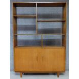 A 1960's vintage teak open bookcase with panel doors to the base. H.178 W.122 D.30cm