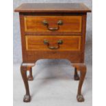 A Georgian style mahogany and satinwood inlaid bedside cabinet with two drawers raised on cabriole