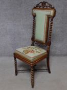 A Victorian carved rosewood side chair in tapestry upholstery on barleytwist stretchered supports.