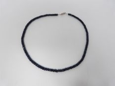 An African Sapphire graduated faceted bead necklace with 18k stamped lobster clasp. Total