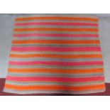 A contemporary linear rug with repeating orange and pink stripes on a grey field 180x200cm