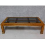 An American walnut coffee table with smoked plate glass inset top. H.42 L.150 W.76cm