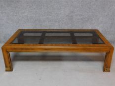 An American walnut coffee table with smoked plate glass inset top. H.42 L.150 W.76cm