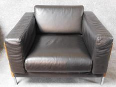 A Robin Day Forum armchair in dark tan leather upholstery. H.55 W.93 D.83cm