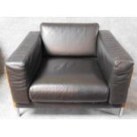 A Robin Day Forum armchair in dark tan leather upholstery. H.55 W.93 D.83cm