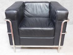A Le Corbusier LC2 style armchair in faux black leather upholstery. H.71 W.92 D.80cm