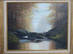 A gilt carved wood framed oil on canvas river landscape by british artist D. J. Lawrence. Titled'