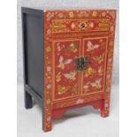 A Chinese red lacquered side cabinet with allover butterfly decoration. H.60 W.40 D.32cm