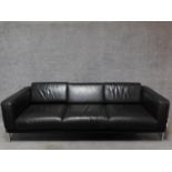A three seater Robin Day Forum sofa in dark tan leather upholstery. H.65 W.210 D.80cm
