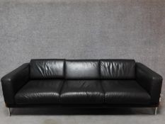 A three seater Robin Day Forum sofa in dark tan leather upholstery. H.65 W.210 D.80cm