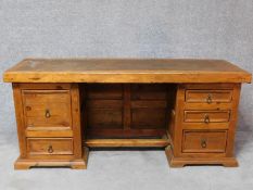 An Eastern teak pedestal desk with an arrangement of five drawers. H.78 W.179 D.59cm