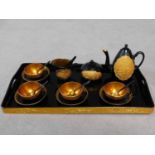 A 20th century gilded black lacquer ceremonial Japanese tea set on gilded tray. It has a moulded