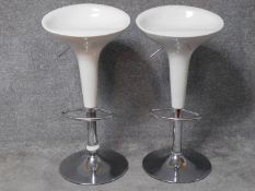 A pair of contemporary moulded adjustable high stools on chrome platform bases. H.87cm