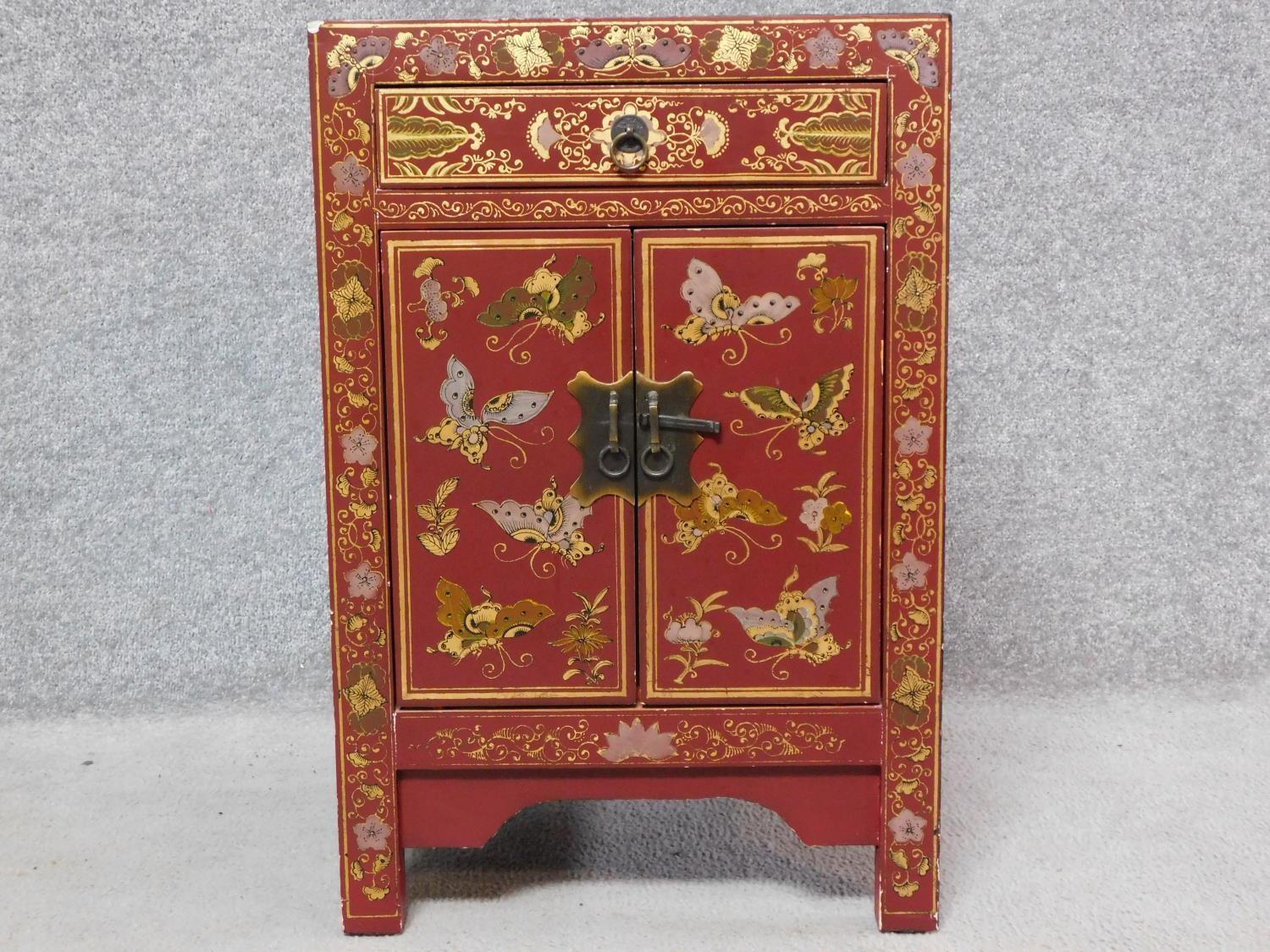 A Chinese red lacquered side cabinet with allover butterfly decoration. H.60 W.40 D.32cm - Image 2 of 6