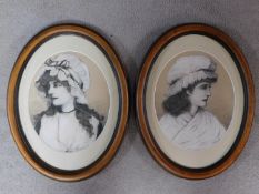 A pair of framed and glazed mixed media artworks depicting two women in Victorian garments, signed