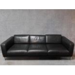 A three seater Robin Day Forum sofa in dark tan leather upholstery. H.65 W.210 D.85cm