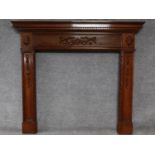 An Adam style mahogany fire surround with ribbon and swag carved central frieze. H.134 W.152cm