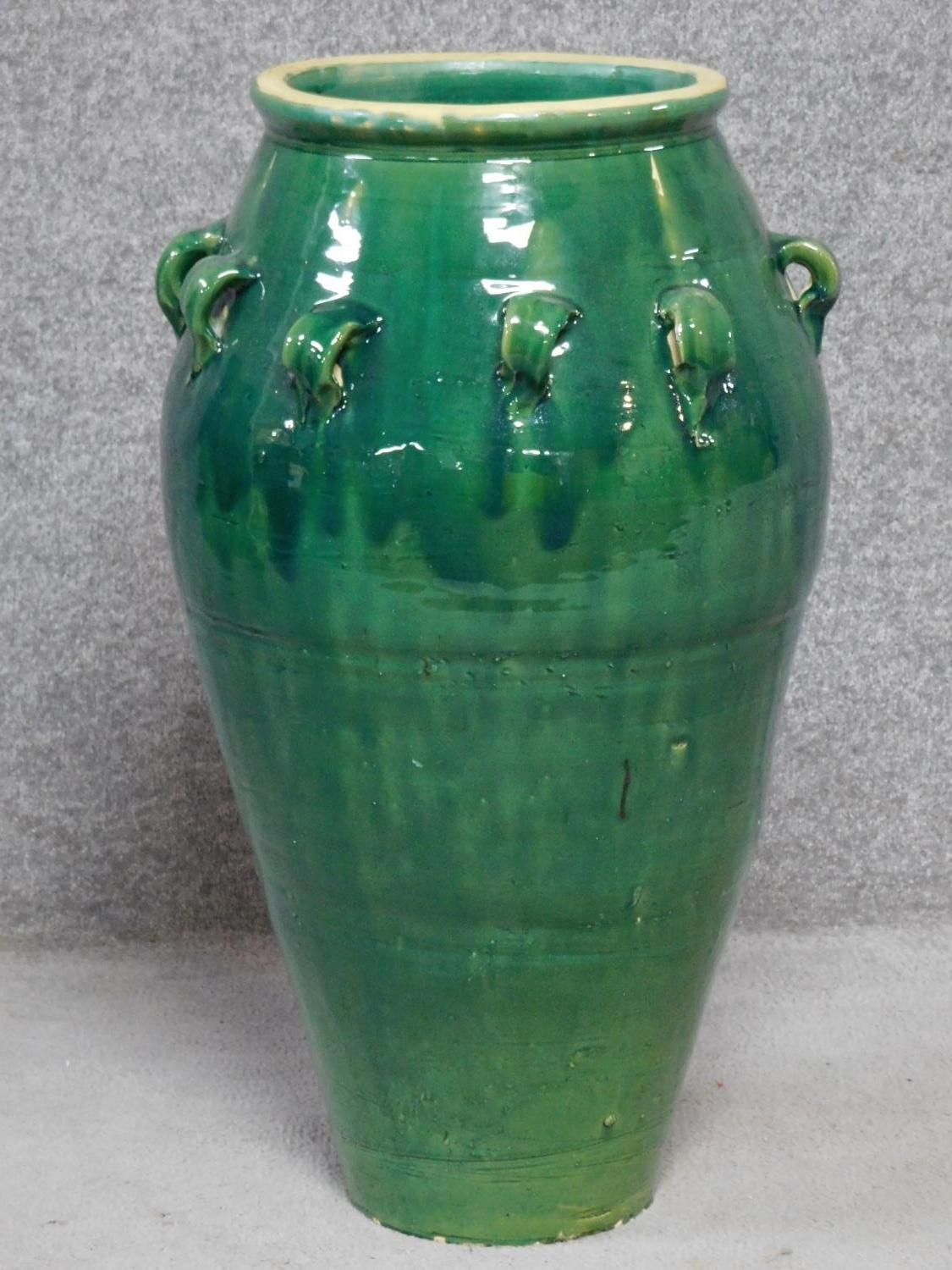 A large green drip glazed sharab wine vessel with handles. H.74cm