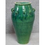 A large green drip glazed sharab wine vessel with handles. H.74cm